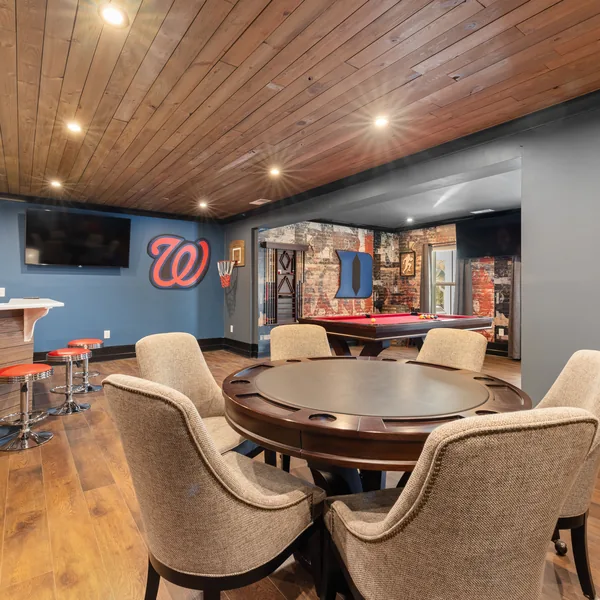 Finished basement with a built-in bar, seating area, and recessed lighting