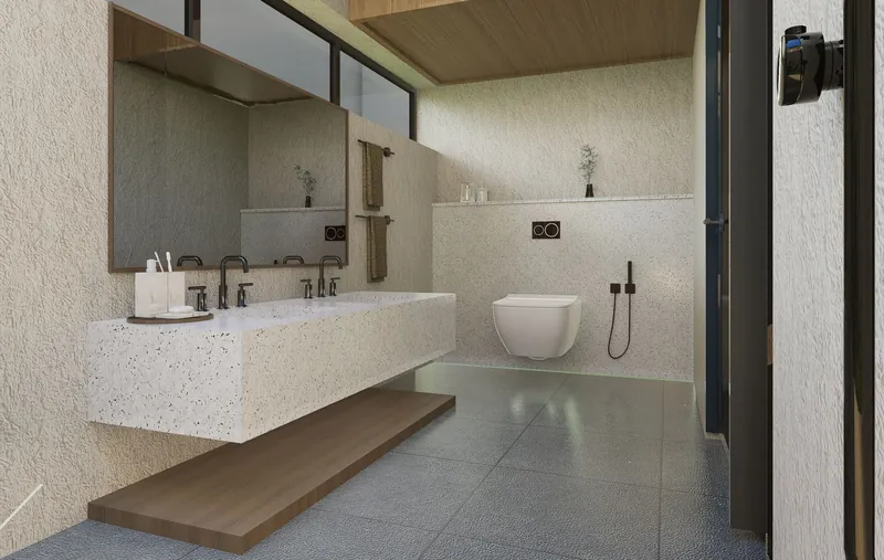 Floating vanity and wall-hung toilet above a continuous curbless tile floor