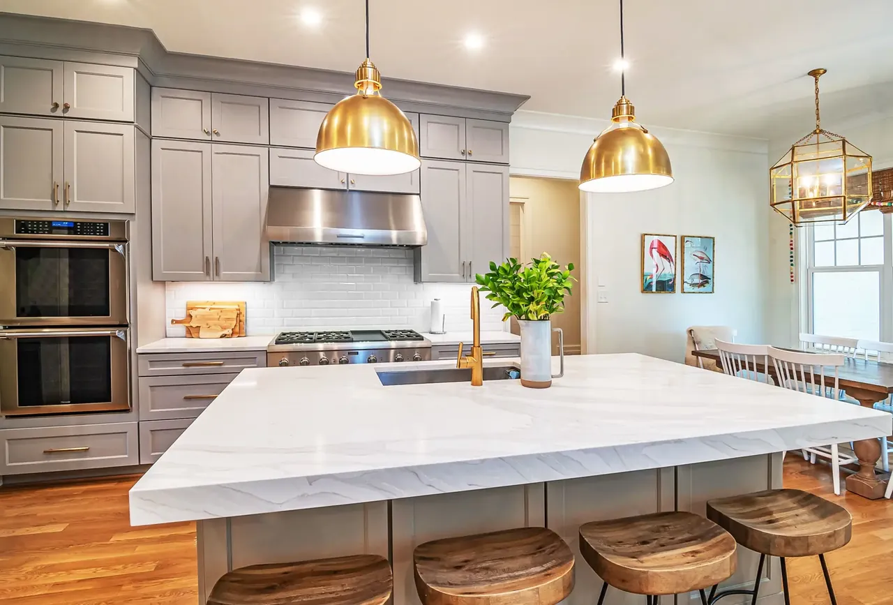 Remodeled Findlay kitchen with a marble-topped island, pendant lighting, and full-height cabinetry