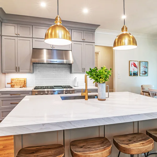 Remodeled Findlay kitchen with a marble-topped island, pendant lighting, and full-height cabinetry