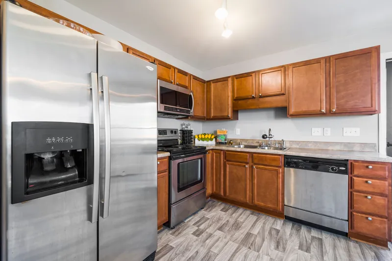 Dated oak kitchen cabinets with laminate counters, ready for refacing or replacement