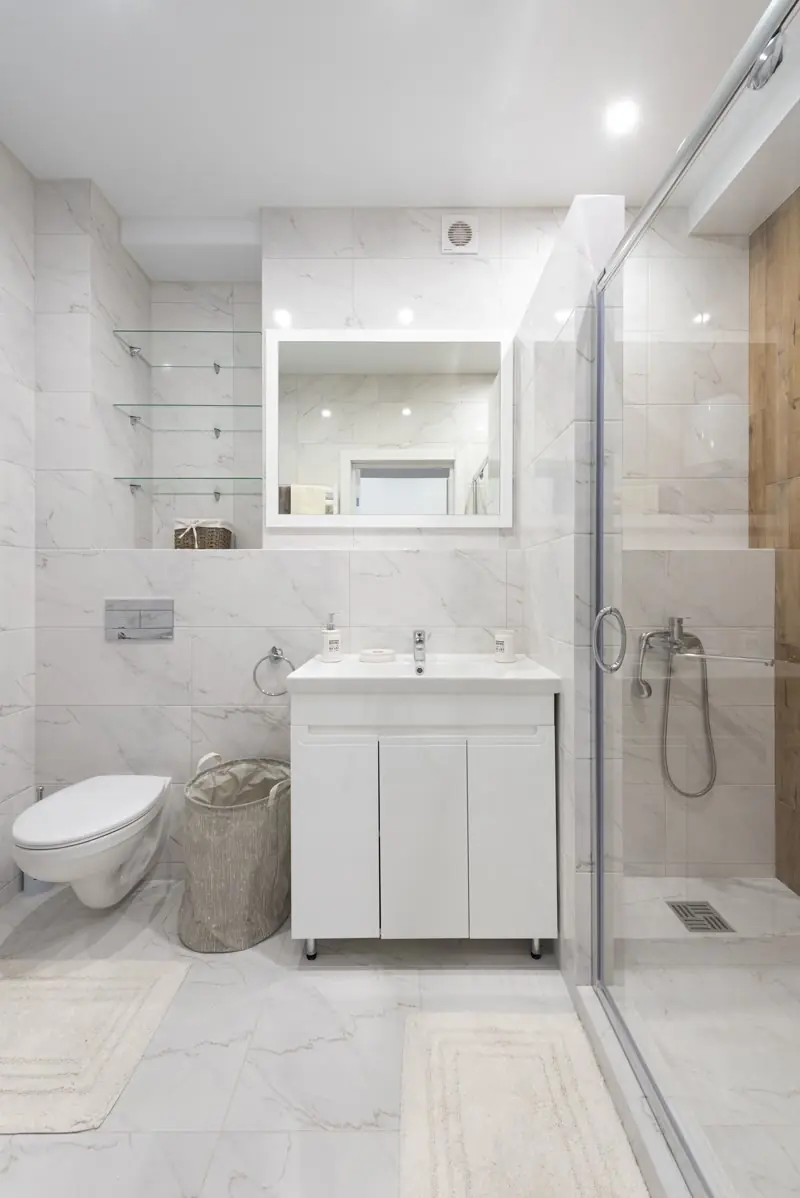 Tiled shower walls and pan built over a waterproofed substrate in a finished bathroom